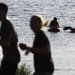 Audience members walking near Charles River