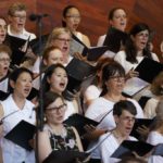 Singers from Landmarks Orchestra's One City Choir sing onstage at the Hatch Shell.