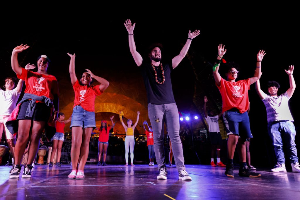 Performers in t-shirts and shorts are onstage at the Hatch Shell after the piece Full Circle by Jake Gunnar Walsh and Devin Ferreira.