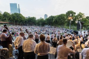 Landmarks Orchestra members look out into the audience gathered around the Hatch Shell.