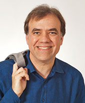 Headshot of Christopher Wilkins smiling at the camera.