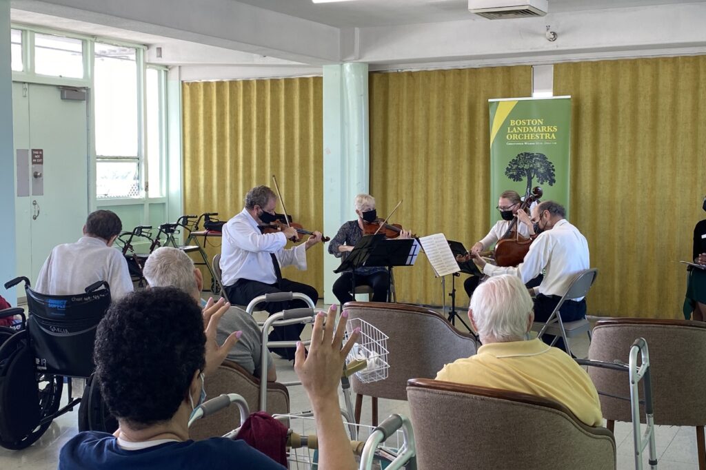 Residents enjoy and dance to the Landmarks String Quartet's performance at a Music and Memory performance.