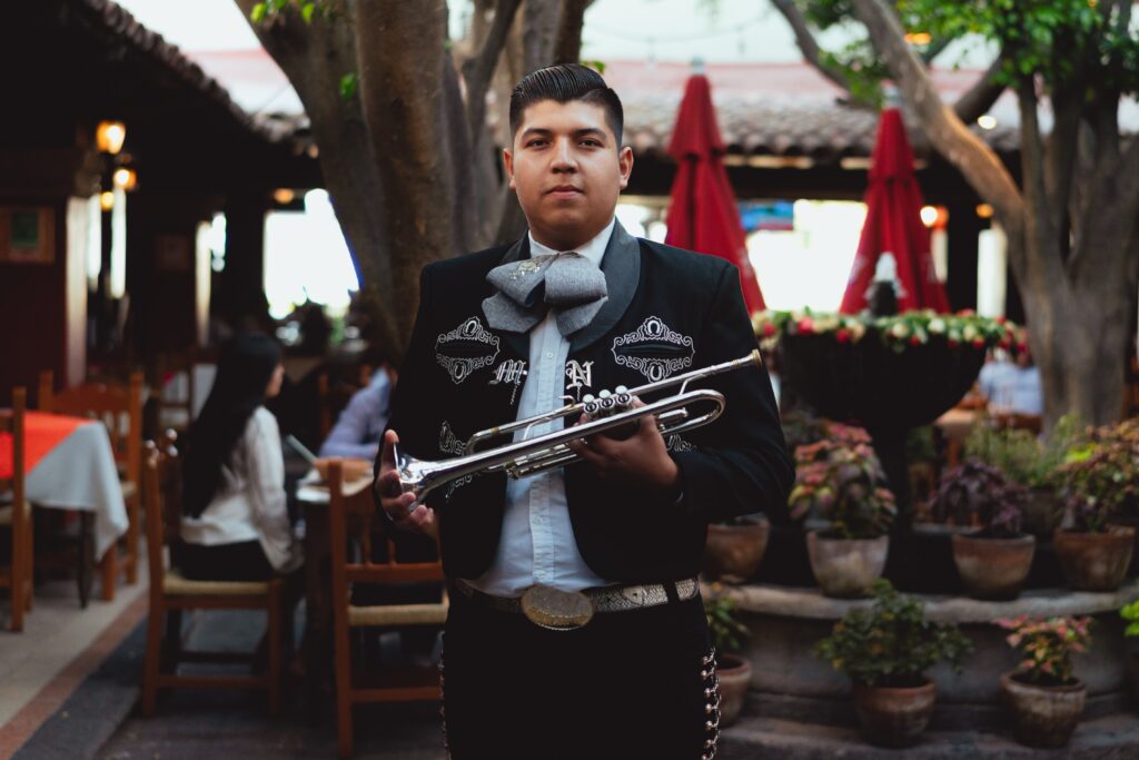 Mariachi performer holding a trumpet.