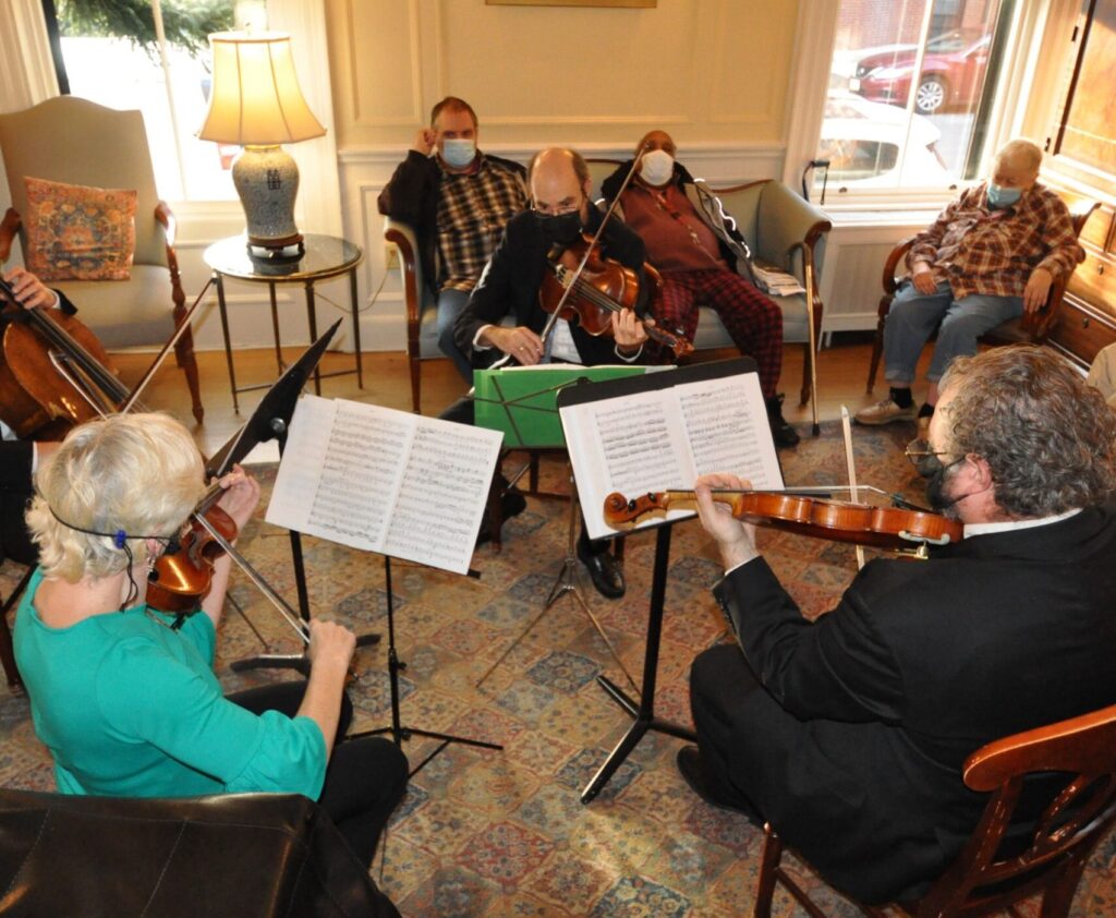 Residents of a nursing facility watch Landmarks string quartet perform.