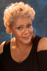 Headshot of Tichina Vaughn. She's looking up at the camera, smiling.