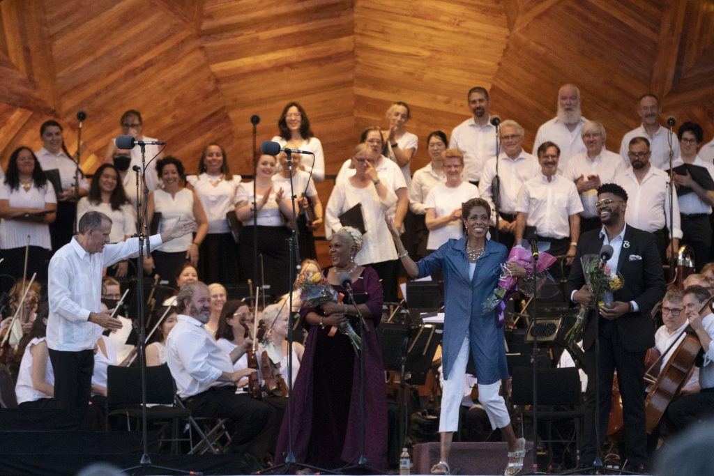 From left - Music Director of Landmarks Orchestra, Christopher Wilkins, mezzo-soprano, Tichina Vaughn, composer, Dr. Diane White-Clayton, baritone, Phillip Bullock. Behind them are the singers from Coro Allegro.