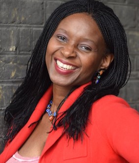Headshot of Ade Solanke - she is a Black woman wearing an orange blazer, smiling at the camera.