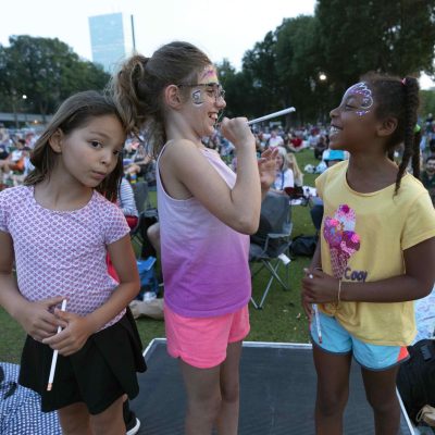 Children learn how to conduct at the Maestro Zone at the Hatch Shell