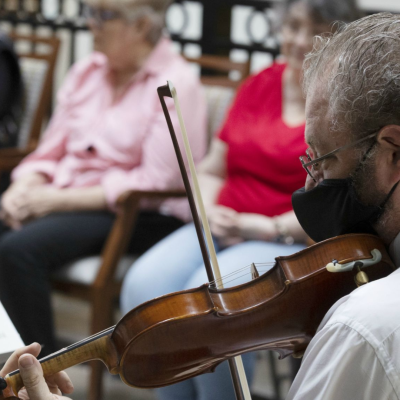 A string player performs at a Music & Memory concert at a nursing facility.