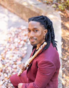 Headshot of DeShaun Gordon-King holding his flute