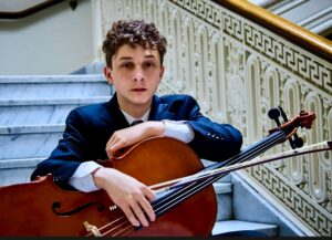 Headshot of Gabriel Jojatu holding his cello
