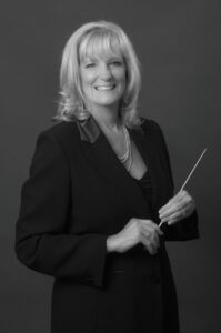 Headshot of Holly MacEwen Krafka holding her baton.
