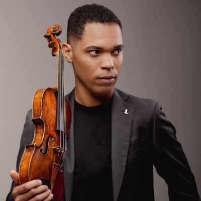 Headshot of Nathan Amaral with his violin